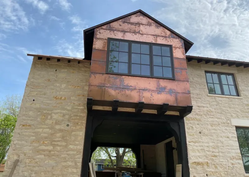 Copper metal panel facade on a stone building for Metal Roof Coating in Bear Creek