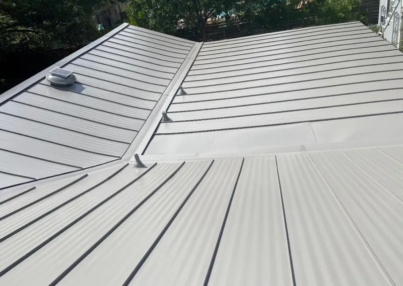 Solar attic fan installed on a metal roof for Roof Ventilation in Bear Creek