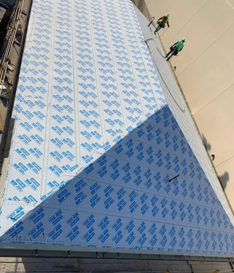 Professional roofers installing underlayment on a metal roof in Bear Creek